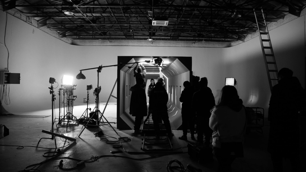 A busy music video set with a lot of staff and equipment.